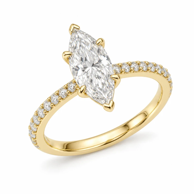 A complete yellow-gold marquise diamond solitaire with six prongs and pavé shoulders, photographed on pure white.