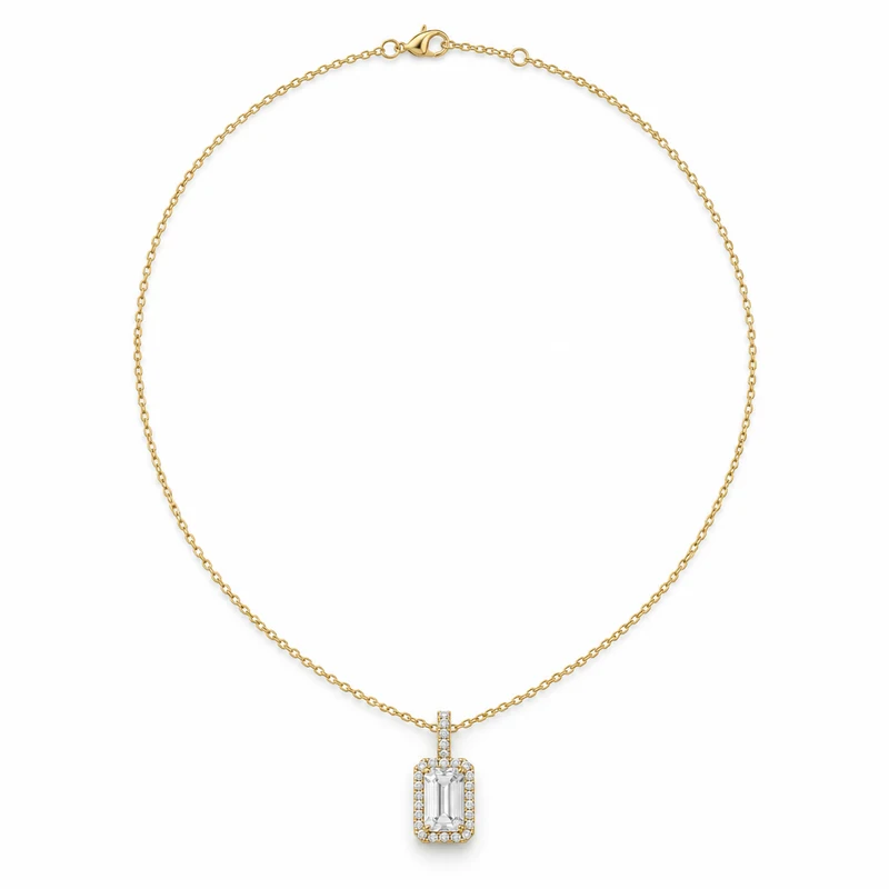 An emerald-cut diamond halo pendant in yellow gold, with its complete fine chain and clasp arranged on pure white.