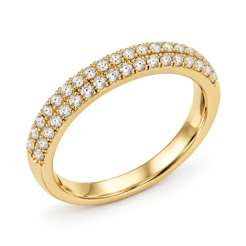 A yellow-gold band with two neat rows of round diamonds across its upper face, on pure white.