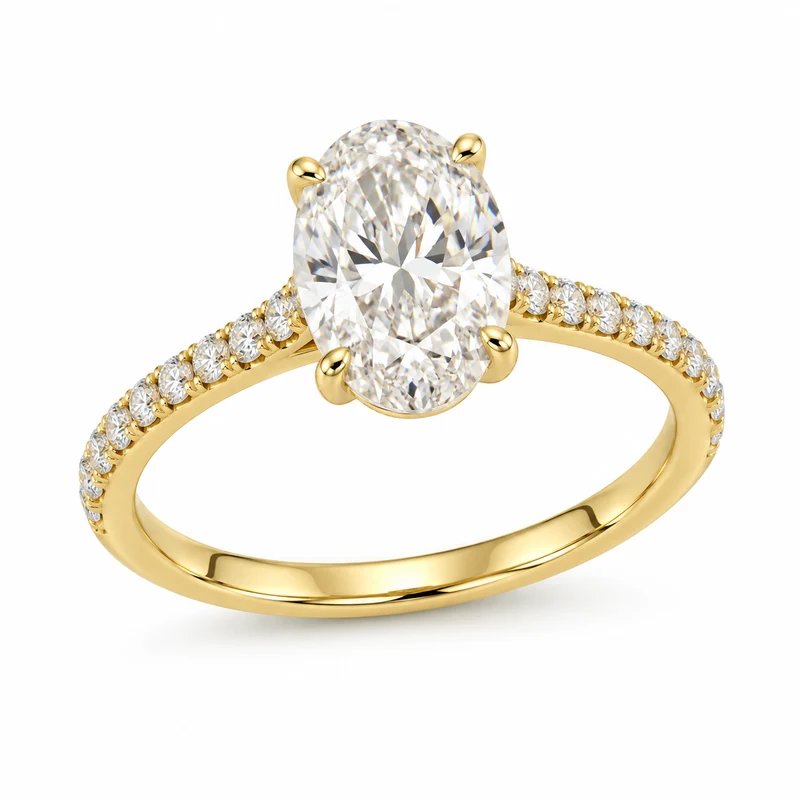 Yellow-gold oval diamond ring with diamond-pavé shoulders, photographed on pure white.