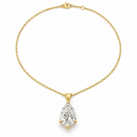 A pear diamond pendant with its complete yellow-gold chain on white.